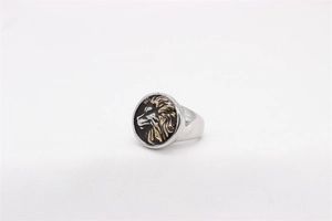 Detailed view of the silver lion head relief on a black round dial for men's steel ring