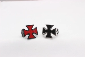 Detail of vintage Gothic iron cross rings featuring red and black enamel inlays