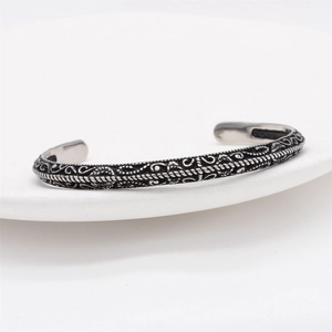Vintage oxidized silver steel cuff bracelet with intricate embossed weave and vine patterns