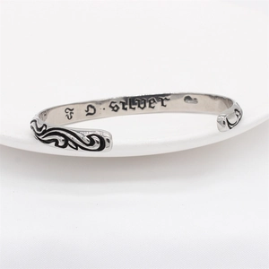 Retro titanium steel cuff bracelet with vintage black wave patterns and polished finish