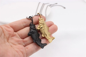 Detail of vintage goldfish pendants in matte black and gold finish with textured scales