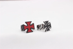 Detail of punk style stainless steel rings with cross patterns and Cuban link textures