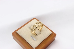 Detailed view of a gold chain ring made of polished stainless steel for men