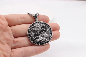 Macro detail of Nordic Viking double wolf pendant with carved runes on vintage steel