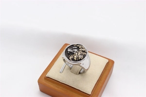 Detailed macro view of the 3D gold lion head emblem on vintage men's steel ring