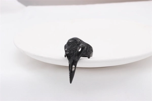 Detail of a black Viking crow skull ring with Celtic knot engravings in a Gothic style