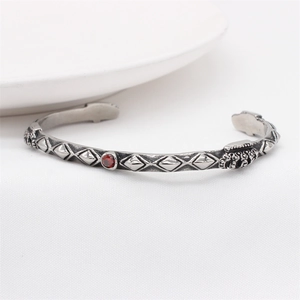 Retro punk crown bangle for men in stainless steel with rivets and red gemstone inlay