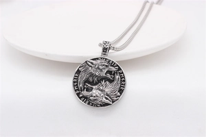 Detailed view of Viking wolf pendant with Norse runes and vintage steel finish