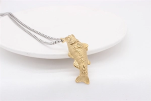 Detailed close-up of a gold koi fish pendant featuring intricate scale texture on a silver chain