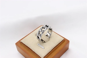 Macro detail of men's titanium steel Cuban link chain ring with vintage oxidized finish