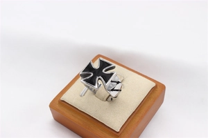 Macro shot of vintage titanium steel ring featuring black enamel Maltese cross detailing