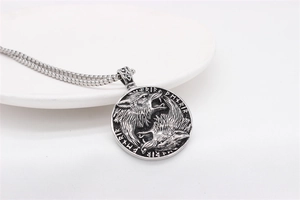 Detail of Viking wolf pendant with runic carvings on vintage stainless steel