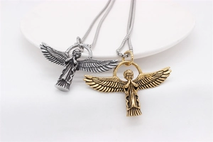 Detailed macro view of vintage angel cupid pendants in silver and gold stainless steel finish