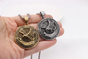 Close-up of gold and silver eagle relief pendants with intricate Philippine Eagles engravings