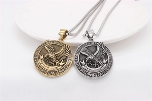 Close-up of gold and silver eagle pendant necklaces with fraternal order engraving