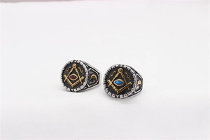 Detail of vintage Masonic steel rings with compass symbol and red/blue gemstones