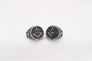 Detailed close-up of retro Freemasonry rings with red and blue gemstones in steel