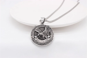 Detailed relief of vintage eagle pendant with fraternal order engravings and box chain