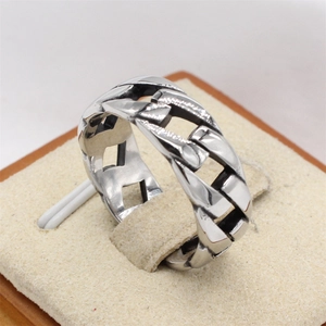 Polished silver stainless steel Cuban link chain ring for men on a display stand