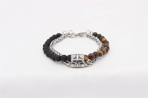 Close-up of retro cross bead bracelet featuring matte onyx and tiger eye stones