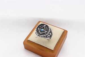 Detail of vintage Masonic ring with blue eye symbol and embossed square and compasses