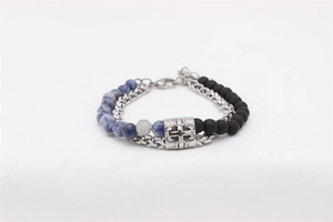 Detail of beaded bracelet with blue stones, black beads and silver cross charm