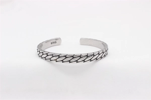Detail view of vintage S925 sterling silver cuff bracelet with oval embossed patterns