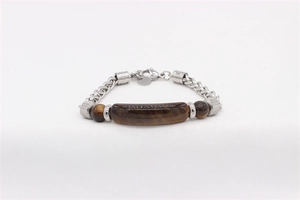 Detailed macro view of men's stainless steel woven bracelet with tiger eye stone inlay