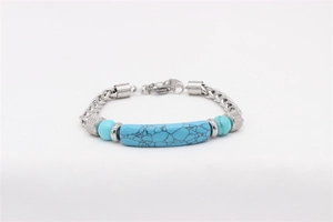Detail of turquoise stones and robust stainless steel curb chain on men's bracelet