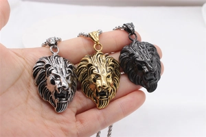Close-up of roaring lion head pendants in gold, silver, and black finish with bead chains