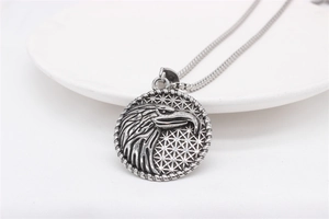 Macro shot of men's eagle head pendant with honeycomb texture and stainless steel chain