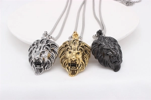 Detailed trio of silver, gold, and black lion head pendants with embossed relief texture