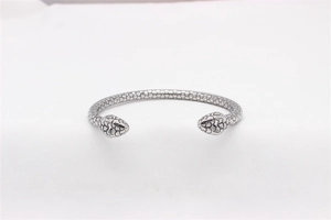 Detail of silver snake-shaped bangle with scale textures and double snake heads