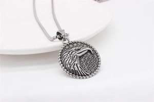 Detailed close-up of eagle relief pendant with geometric star pattern in vintage silver steel