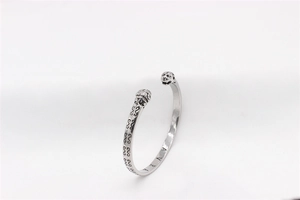 Detailed view of vintage steel tiger head bracelet with engraved textures and AVRA lettering