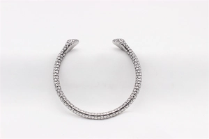 Macro shot of silver stainless steel snake bangle featuring detailed hexagonal scale texture