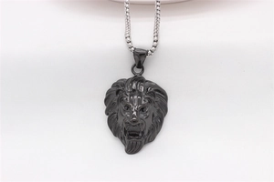 Macro detail of matte black lion head pendant with intricate mane engraving and silver chain