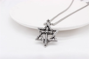 Close-up of vintage steel hexagram cross pendant with gothic textured finish and chain