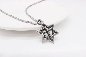 Detailed view of vintage steel star of david cross pendant with intricate engraving