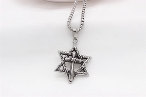 Detailed macro shot of vintage silver hexagram cross pendant with textured finish