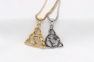 Gros plan des pendentifs triangle noeud celtique dorés et argentés avec détails serpent