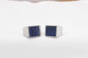 Detail shot of square blue lapis stone with gold flecks on polished steel ring band