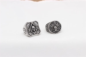 Detailed macro view of vintage Masonic skull rings in oxidized stainless steel with engraving