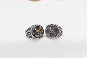 Macro shot of retro stainless steel eagle ring with gold and silver dual-tone relief
