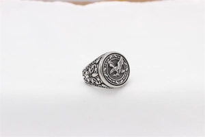 Macro detail of retro eagle relief and floral carvings on mens steel ring