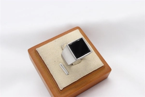 Detail view of square black gemstone inlay on polished men's silver steel signet ring