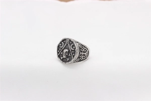 Detailed view of vintage steel signet ring with Masonic symbols and skull engravings