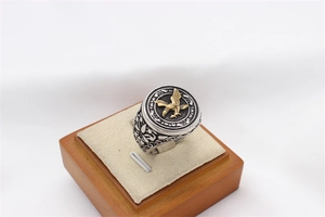 Detailed view of a vintage men's eagle ring with silver band and gold eagle relief