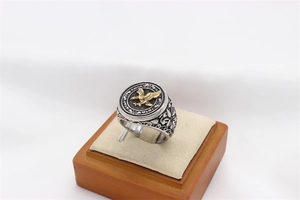 Detailed side view of vintage eagle ring with golden relief and floral steel engraving