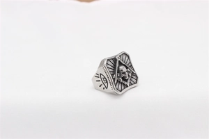 Macro view of gothic skull and Masonic symbol engraved on retro stainless steel ring